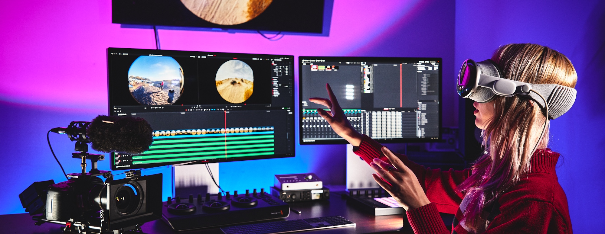 student around a work table with computer and media equipment
