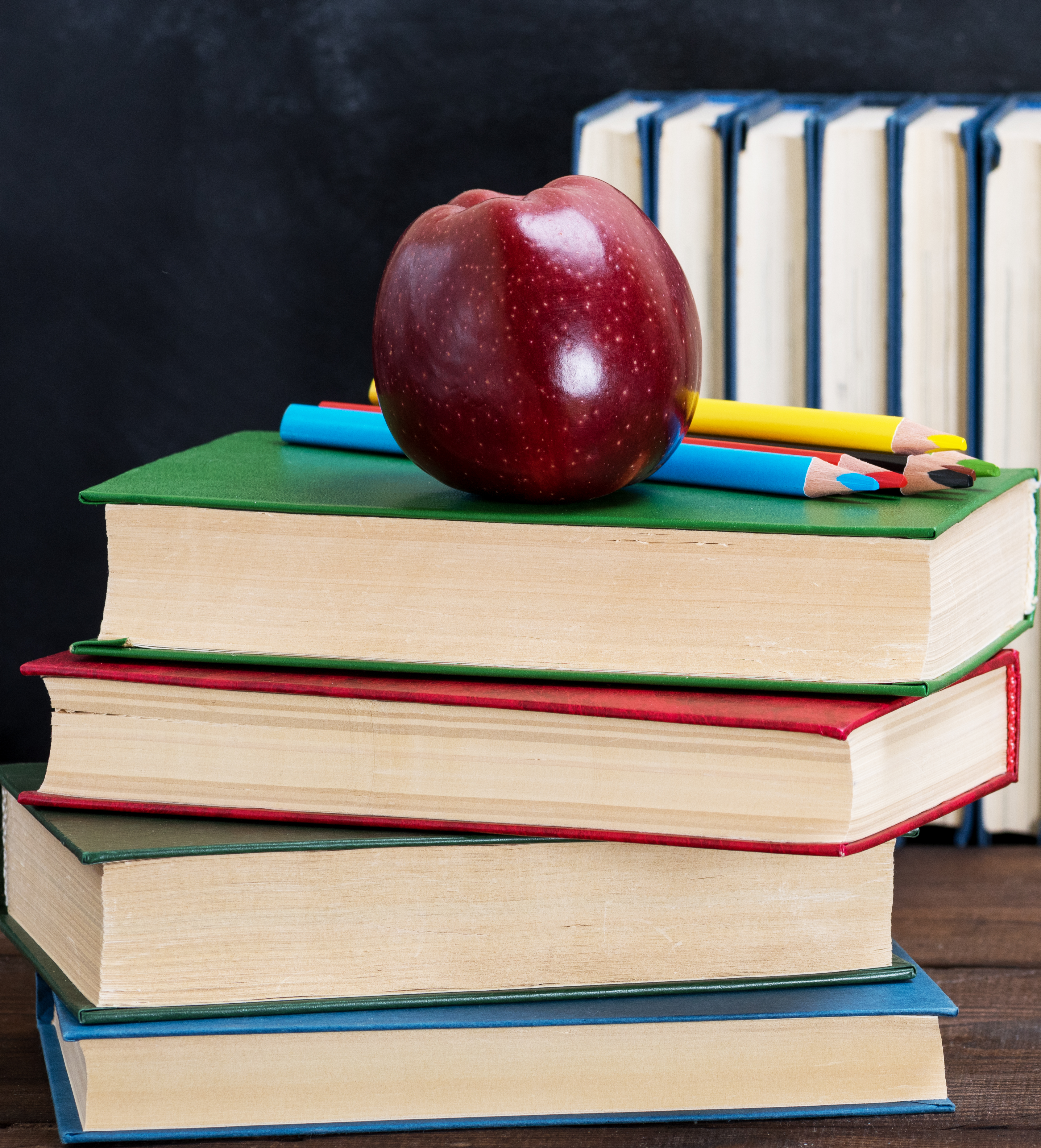 Books and red apple