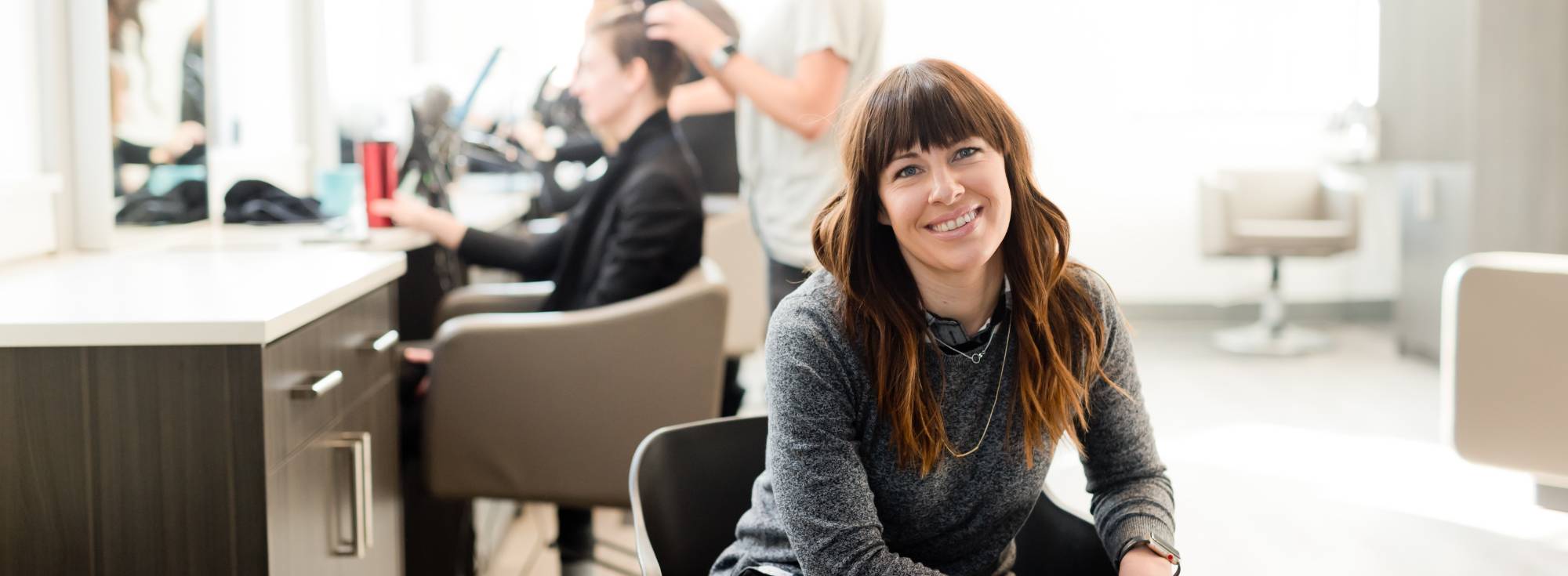 salon manager sitting in a chair