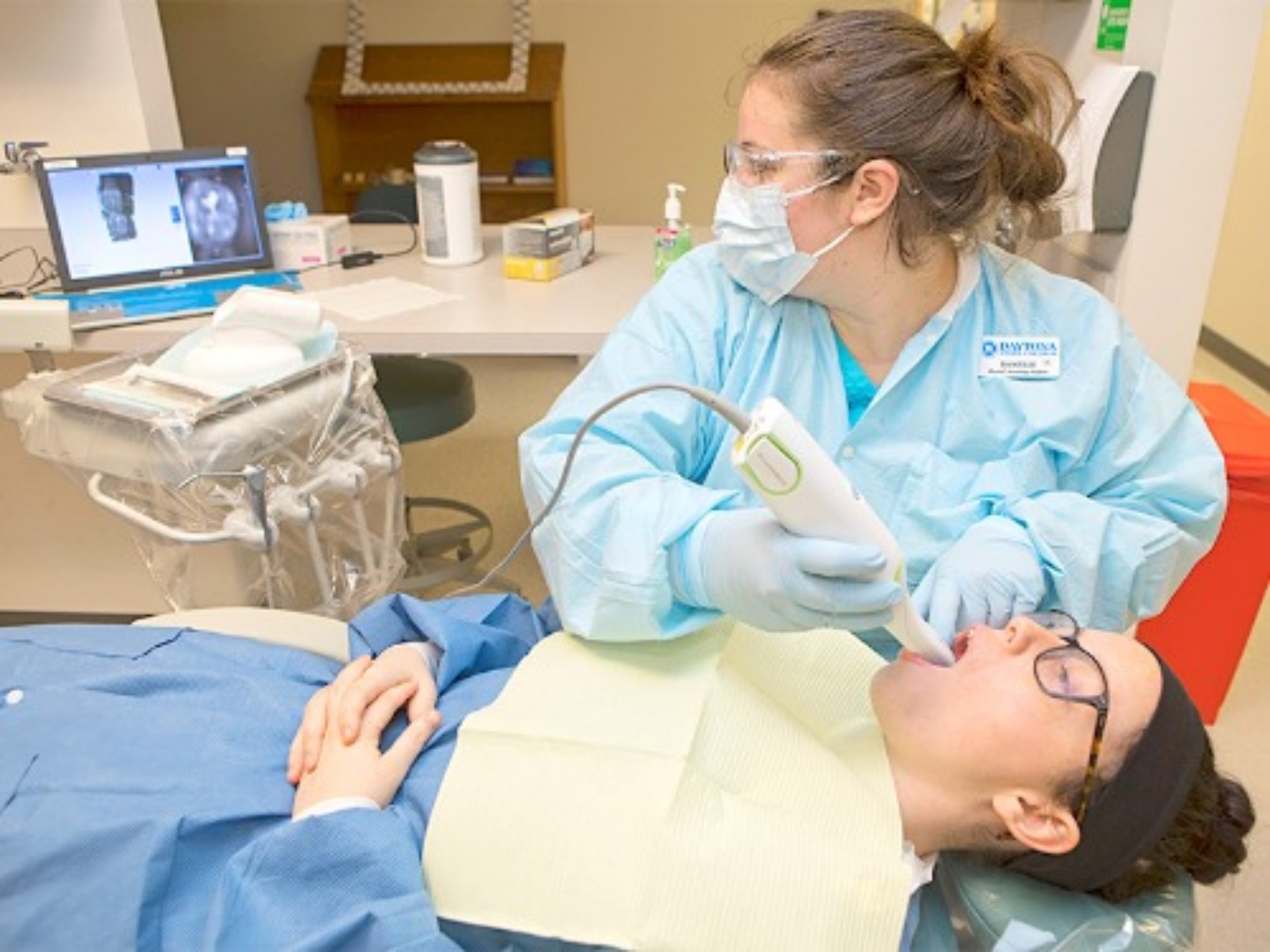 Dental student practicing in class. 