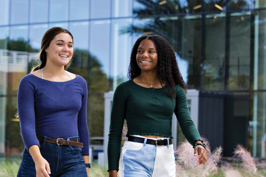 two student walking outside of the student center