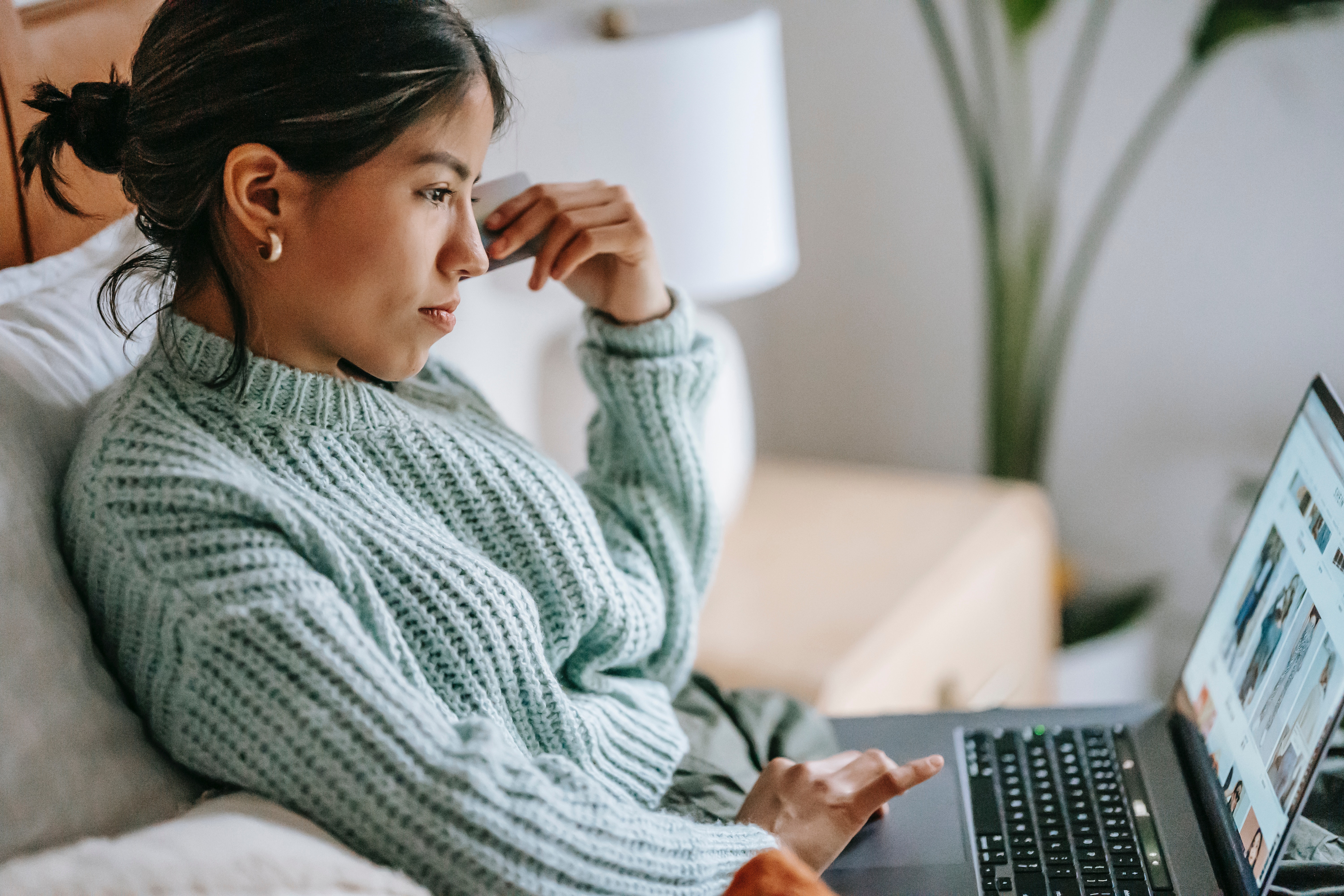 student on couch on laptop