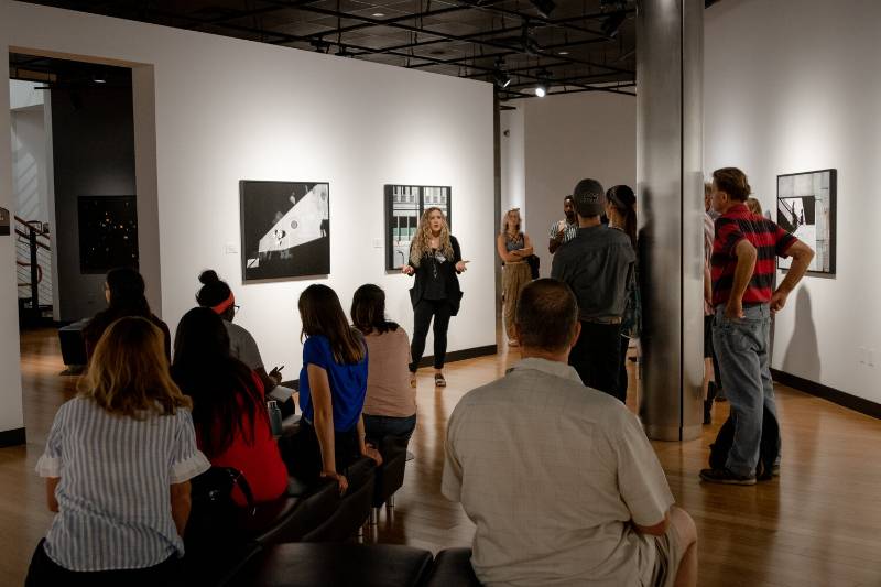 photography exhibit with curator and guests