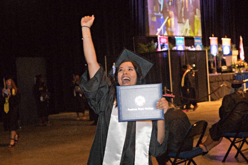graduate celebrating walking across stage