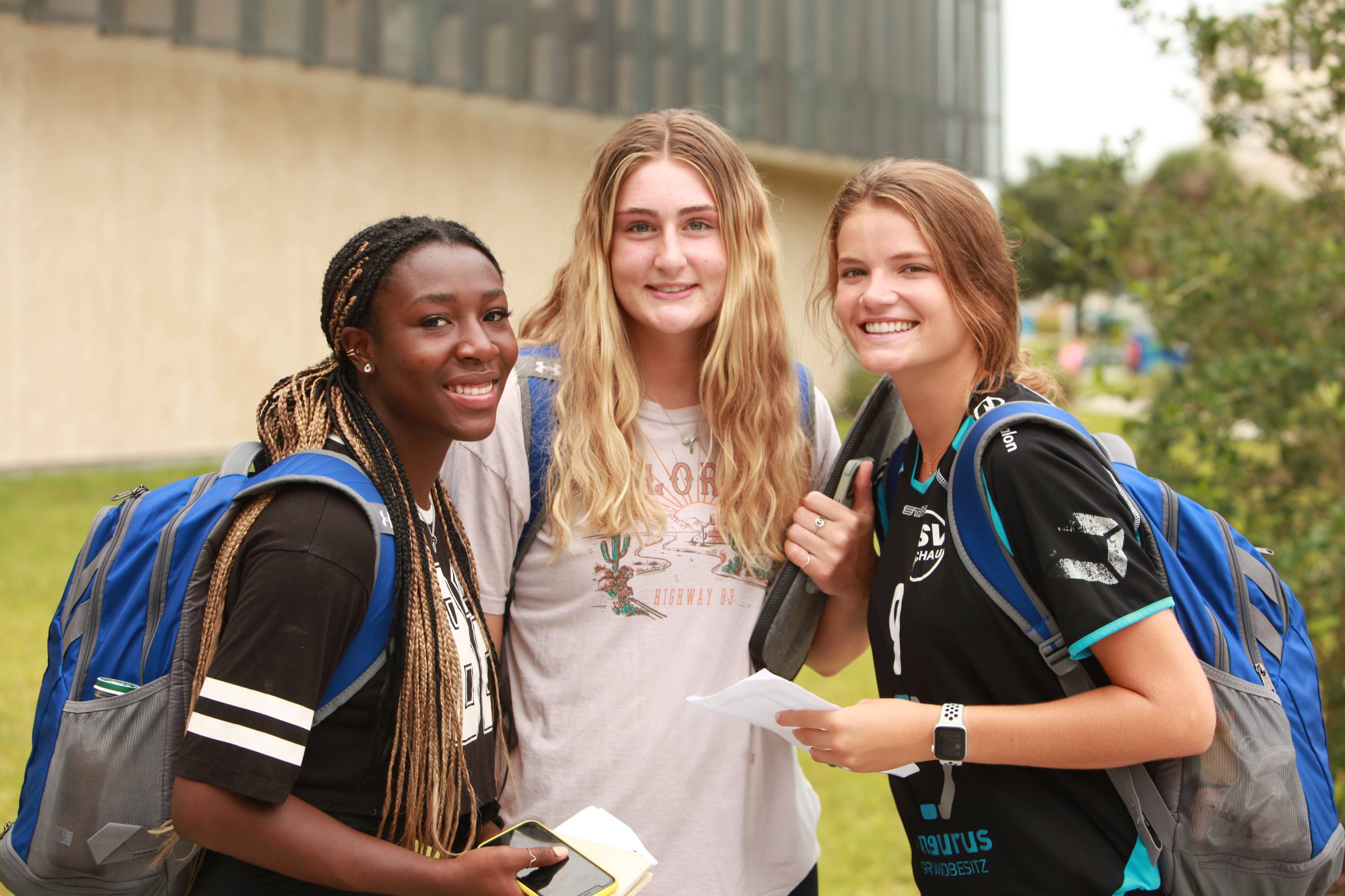 Three students outside the student center on campus. 