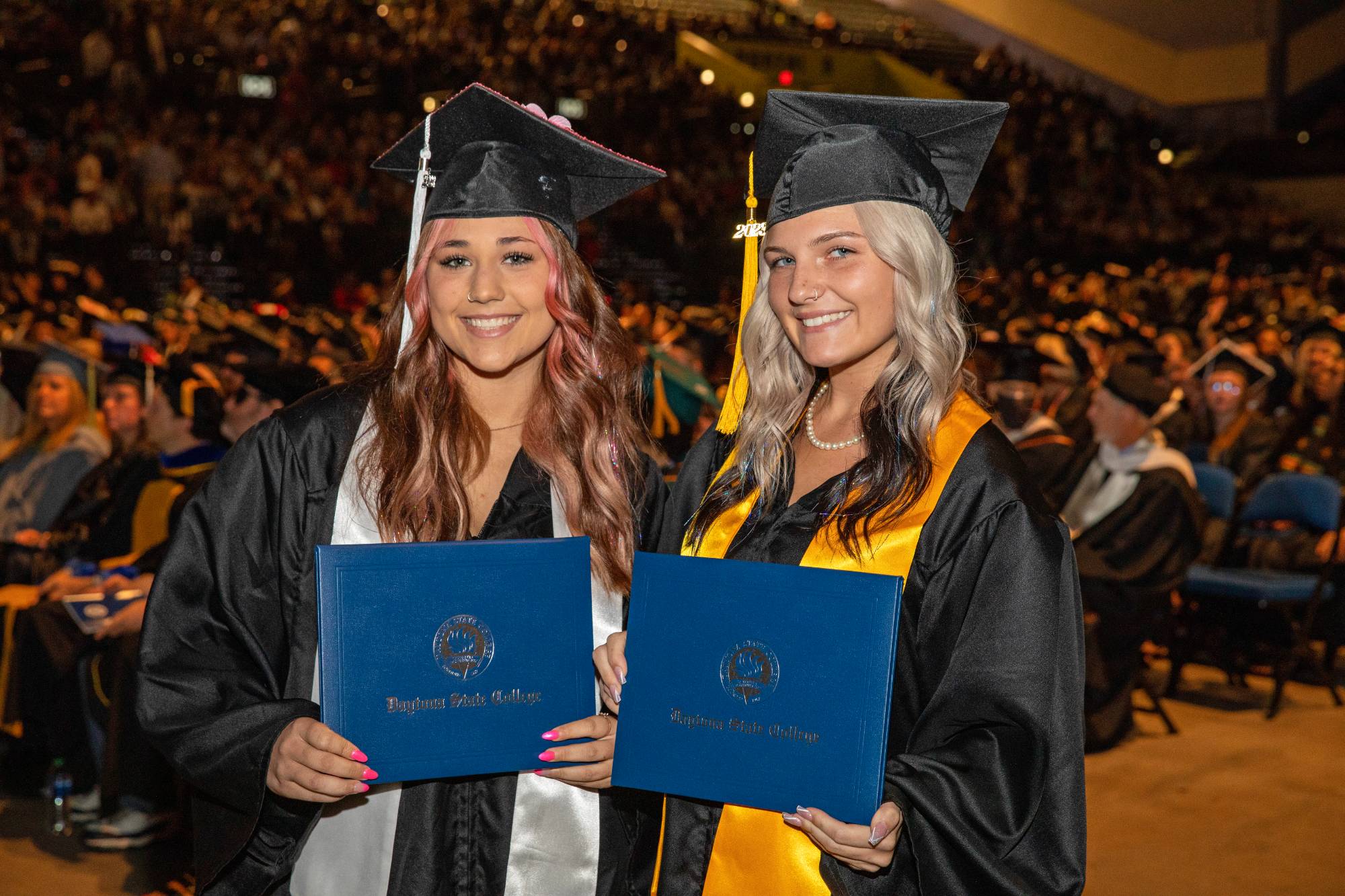 Two new graduates at commencement. 