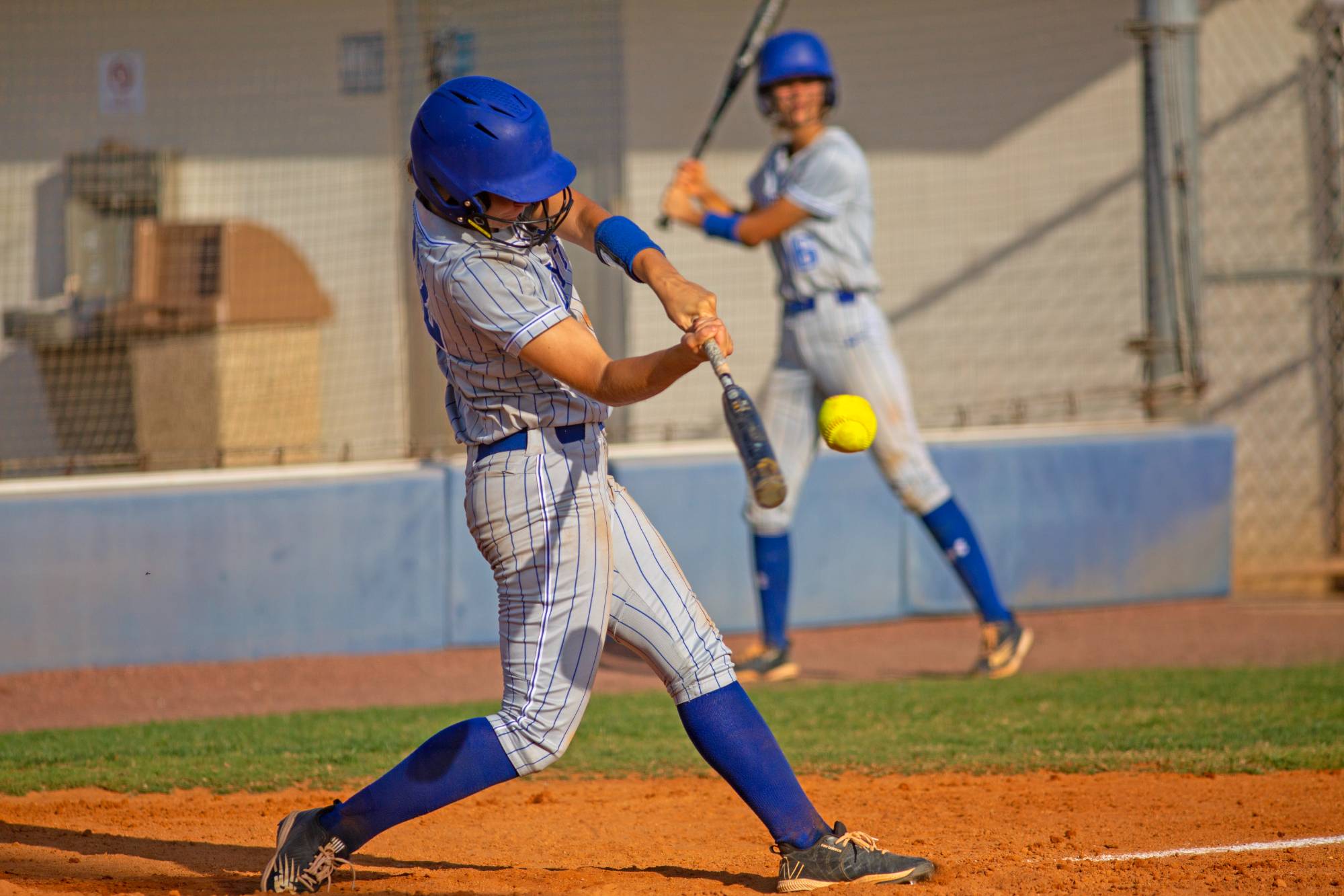 A softball player at bat. 