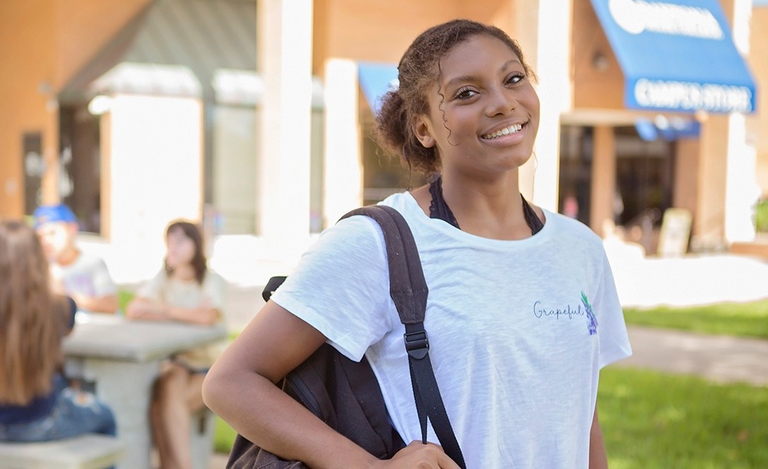 Student with backpack outside.