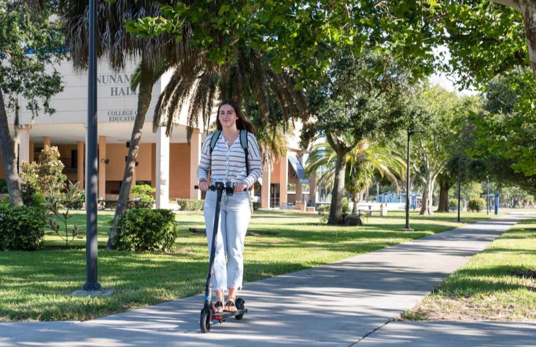 A student going to class on a scooter. 