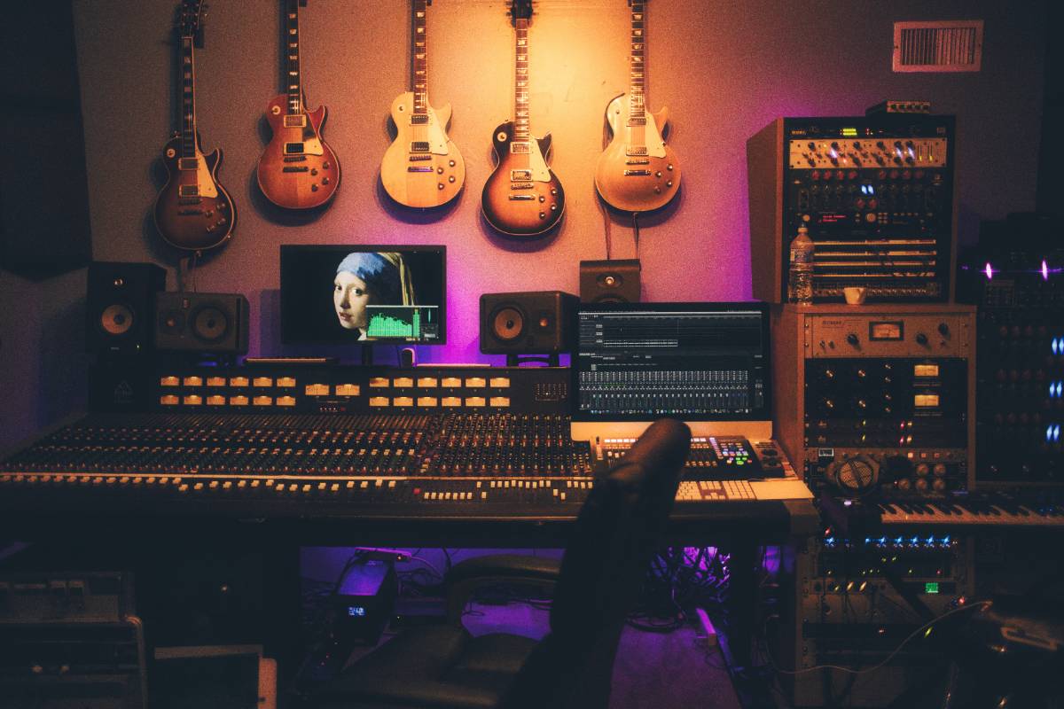 music production studio with guitars on the wall