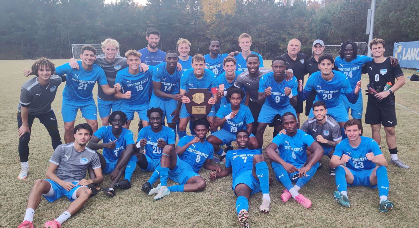 Men's soccer team celebrating after winning the district title. 