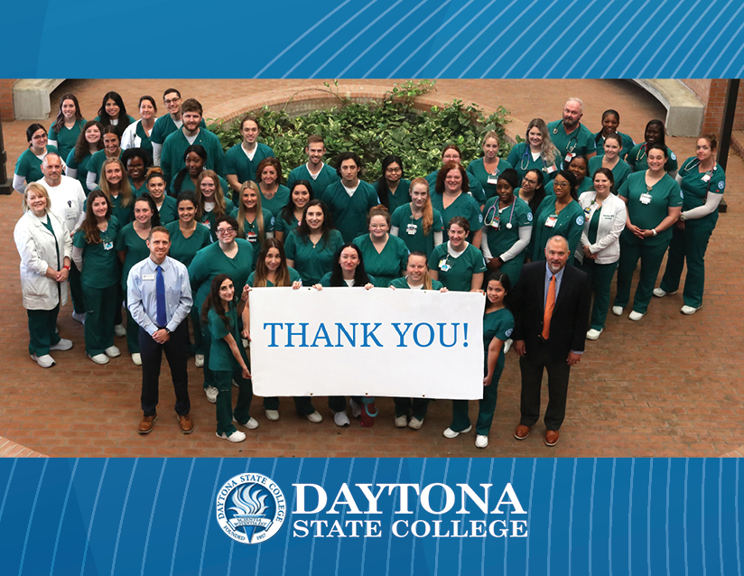 DSC nursing faculty and students holding a thank you banner. 