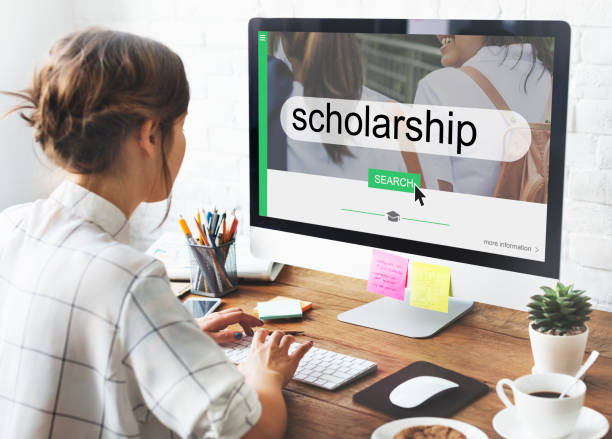person applying for scholarship on a computer