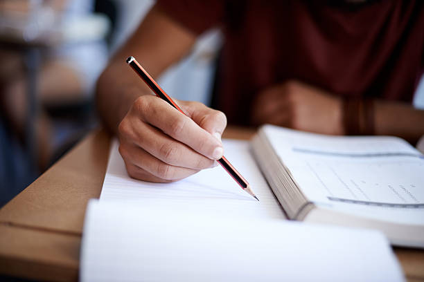 person writing in a notebook