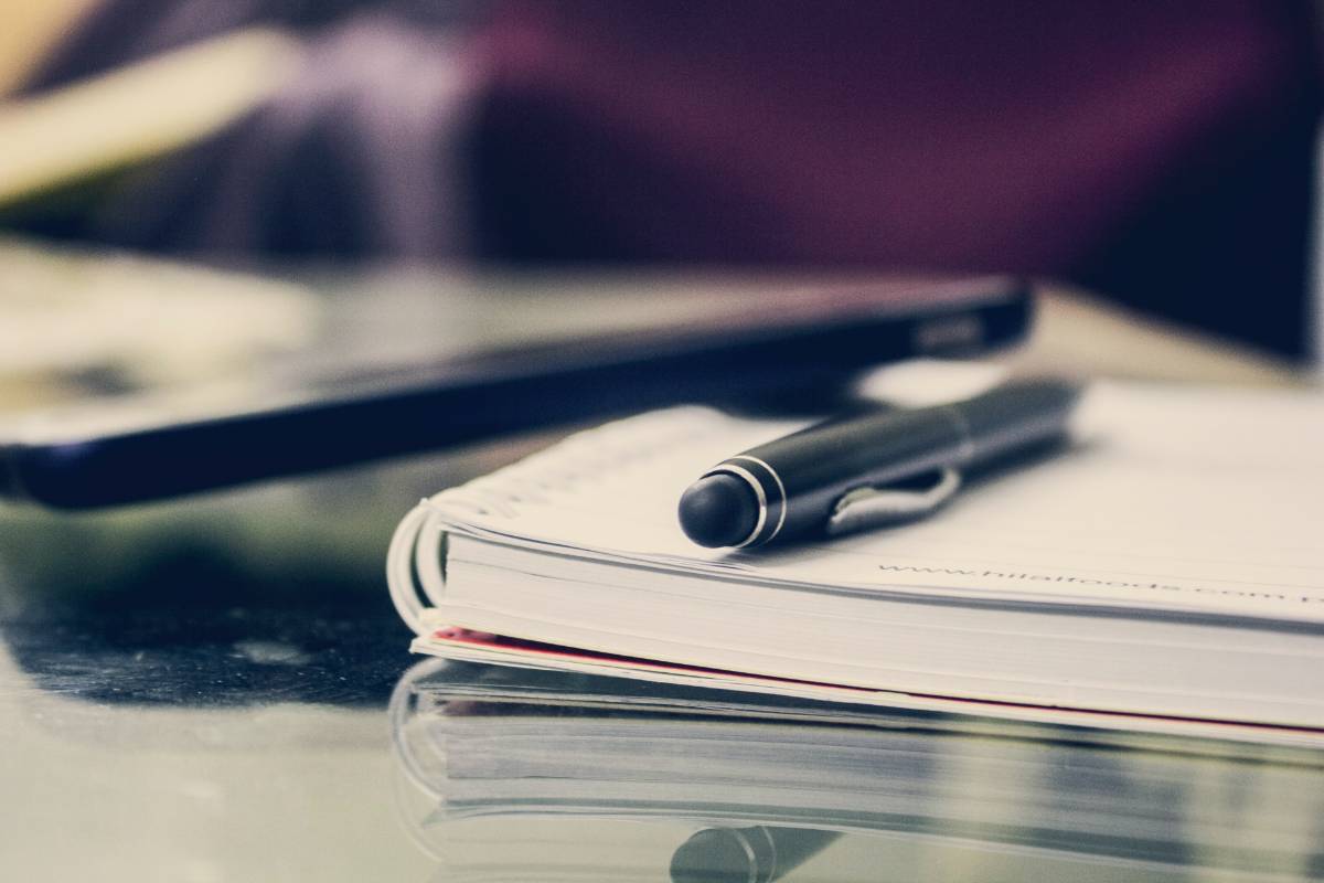 notepad and pen on a desk